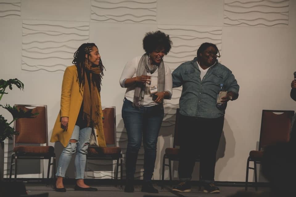 On stage laughing with colleagues